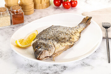 Baked Dorado fish served lemon