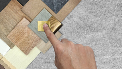 interior architect selects material samples including gold stainless, wooden tiles, stone ceramic...