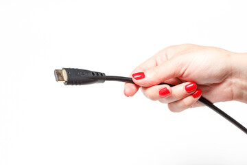 Two connectors for TV in hands with red manicure on white background