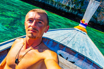 Tourist on Koh Phi Phi island Thailand with longtail boats.