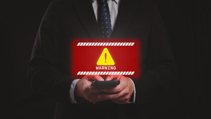 Businessman using smartphone with system warning message icon for malware attack. Cyber security...
