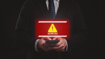 Businessman using smartphone with system warning message icon for malware attack. Cyber security protection, online risk and hacking concept.