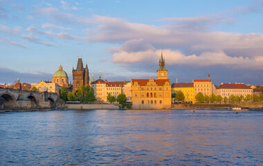 Naklejka premium View of old town with Charles Bridge (Karluv Most) on Vltava river and Old Town Bridge Tower, famous tourist destination in Prague, Czech Republic (Czechia), at sunset