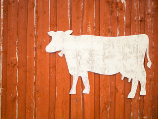 Red rustic wooden barn facade..  with cow stencil for text, farming concept