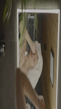 Caucasian female in her 40s is making her daily skin care routine