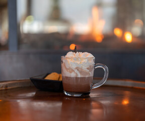 Warm chocolate milk with whipped cream.