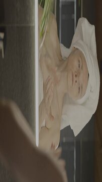 Caucasian female in her 40s is making her daily skin care routine