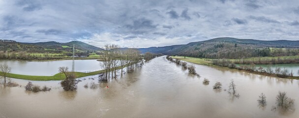 Drone image of the German river Main during a flood with flooded trees on the banks