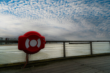 Blankenberge with the sea and different weather conditions.  Belgium coast toerism. 
lifebuoy on the north sea, belgian coast for the safety of the people. Photo for safety and rescuers in Belgium.