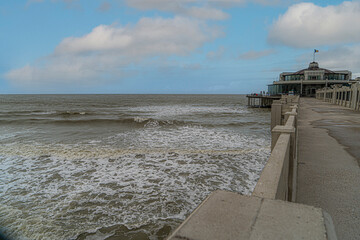 
the pier of the Belgian picket fence on the Belgian coast or the Flemish coast. Tourism Belgian coast with beautiful weather conditions. North Sea tourism