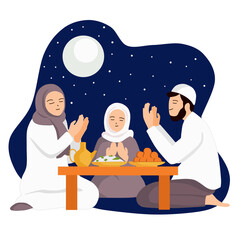 Muslim family praying before eating