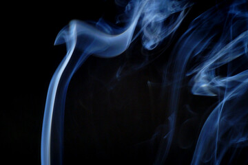 real blue cigarette smoke on a black background