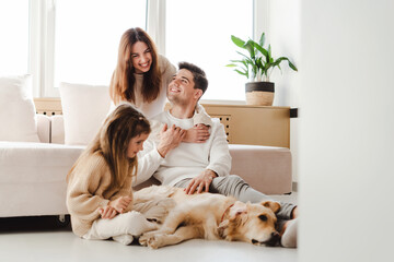 Smiling family, young mother, father and little daughter relaxing together, woman hugging man - obrazy, fototapety, plakaty