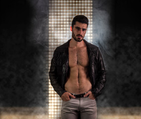 Photo of a rugged man wearing a black leather jacket with no shirt underneath