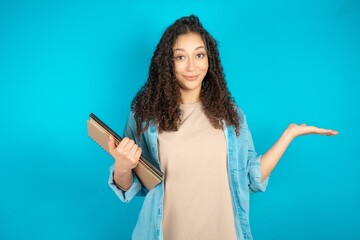 Cheerful cheery optimistic Young beautiful teen woman holding two palms copy space