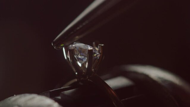 Jeweler Setting Precious Gemstone in Ring with Bright Illumination