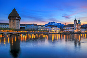 Luzern Kappelbrucke bridge and Jesuten church with Pilatus mountain at background in the evening view, Switzerland