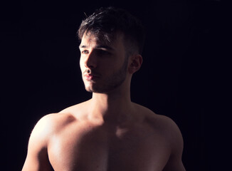 Fototapeta premium A Shirtless Man Posing for a Picture