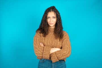 beautiful caucasian teen girl wearing brown sweater Pointing down with fingers showing...