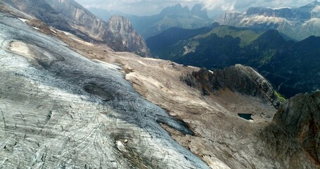 The Marmolada glacier in summer: Aerial view of the last and the only glacier of the Dolomites, UNESCO heritage, near the town of Canazei, Italy - August 2018 - global warming and melting glaciers