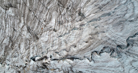 The Marmolada glacier in summer: Aerial view of the last and the only glacier of the Dolomites, UNESCO heritage, near the town of Canazei, Italy - August 2018 - global warming and melting glaciers