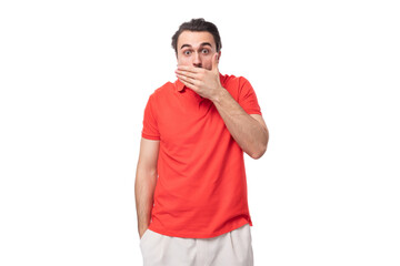 young brunette man in a red corporate t-shirt on a white background with copy space