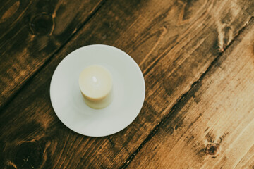 Pillar candle burning in farmhouse environment