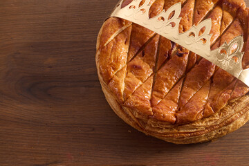 Epiphany cake on wooden table. Galette des rois traditional Epiphany cake in France