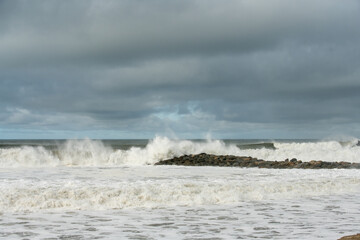 Ventura rock jetty is submerged under crashing waves from the high tides and large swells