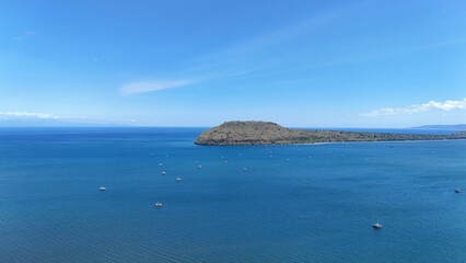 aerial view of natural landscape of blue sea with blue sky and island of alas purwo national park in banyuwangi east java indonesia. Amazing natural scenery in the Bali Strait.