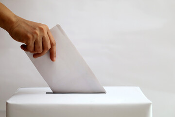 Election voting, hand holding ballot paper for election voting concept isolated white background.