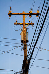 High Voltage Wooden Power Pole On Blue Sky