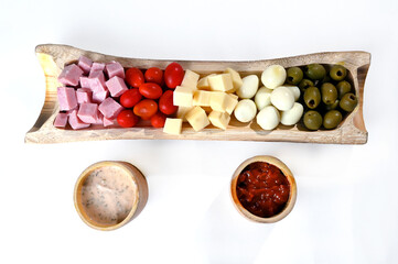 portion of cold snacks cheese ham olive oil