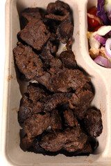 biodegradable lunch tray with roast meat salad herb sauce healthy food protein