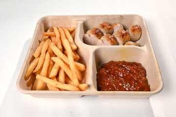 food tray french fries sausage white sausage and red sauce german food