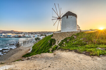 Famous white windmill near the coast of Mykonos island at sunrise