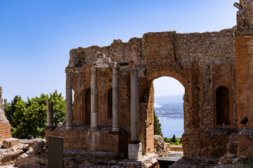 Obraz premium View of old, brick ruins of Ancient Theater of Taormina on a sunny day
