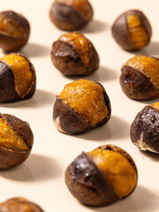 Cooked chestnuts (Castanea mollissima Blume) and sugar-fried chestnuts are popular Chinese street snacks with a sweet taste. Close-up of peeled chestnut