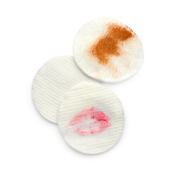 Clean and dirty cotton pads after removing makeup on white background, flat lay