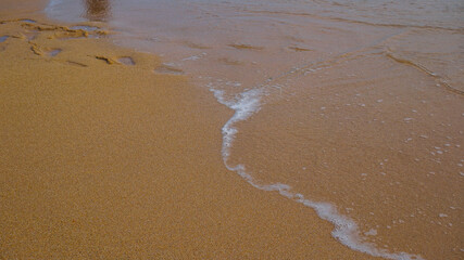 waves crashing on the white sand beach