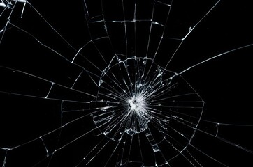 Broken glass on a black background, cracks, shards.