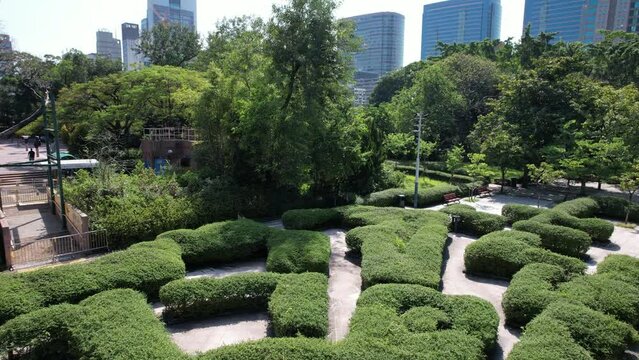 Hong Kong Kowloon Park Green Maze Garden with beautiful flowers and plants in Austin Road Tsim Sha Tsui CBD Kowloon near swimming pool sports center. A concrete forest and a leisure space for citizens