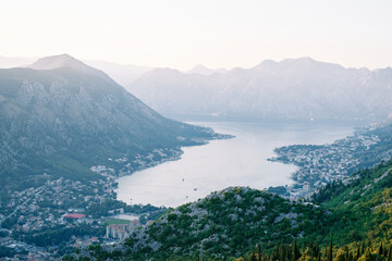 Resort towns on the coast in the valley of the Bay of Kotor, surrounded by mountains. Montenegro. Top view