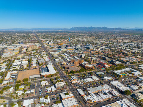 Scottsdale city center aerial view on Scottsdale Road at Main Street with Arizona Canal and McDowell Mountain at the background in city of Scottsdale, Arizona AZ, USA. 