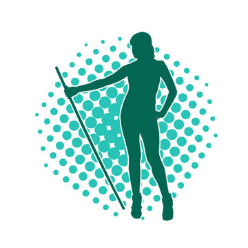 Silhouette of a slim female fighter in standing pose with her staff weapon. A slim woman warrior silhouette carrying toya stick weapon.
