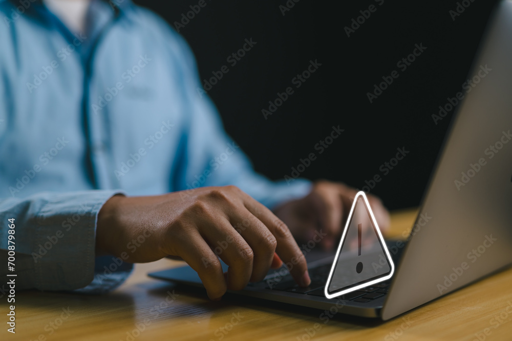 Poster User working on laptop computer with triangle caution warning sign for notification error and maintenance concept, computer virus detected, personal data protection, network security.