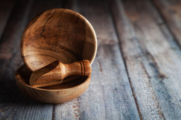 Close-up of Wooden bowls, along with a wooden scoop on a wooden background.