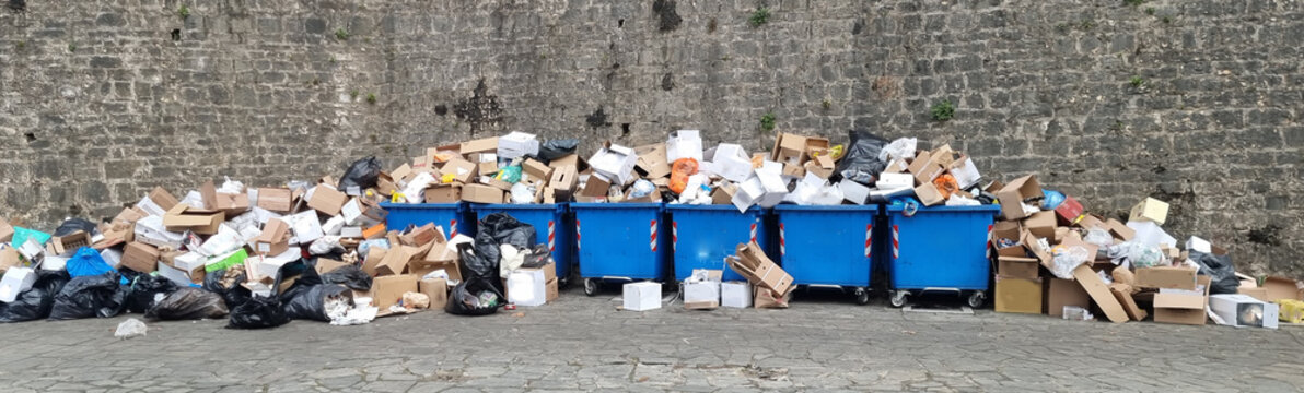 garbages garbage buckets full platic bags boxes on the street