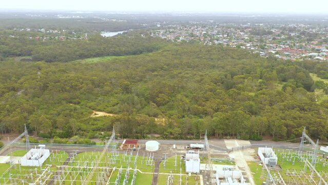 Aerial drone pullback reverse view of an electrical distribution substation for the generation and supply of energy to households and industry located at Picnic Point in Sydney, NSW Australia  