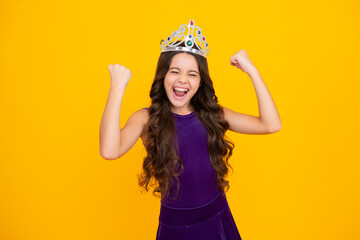 Obraz na płótnie Canvas Excited face, cheerful emotions of teenager girl. Portrait of ambitious teenage girl with crown, feeling princess, confidence. Child princess crown on isolated studio background.